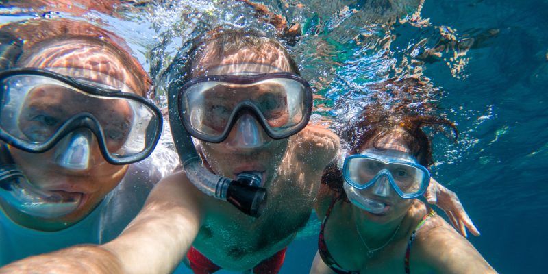 Snorkeling friends making underwater selfie in the sea