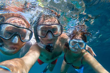 Snorkeling friends making underwater selfie in the sea